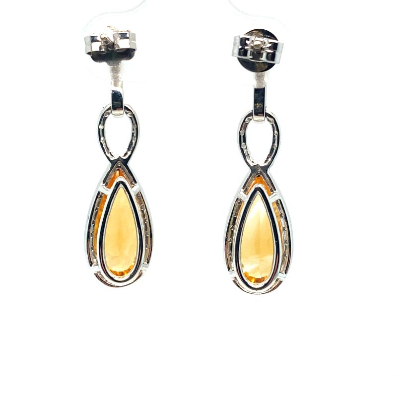 a pair of silver and yellow earrings