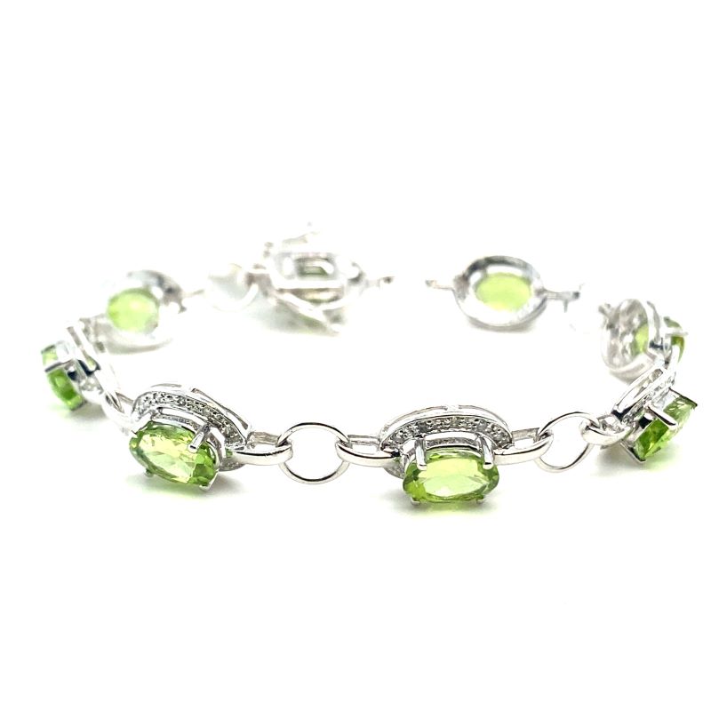 a bracelet with green stones on it