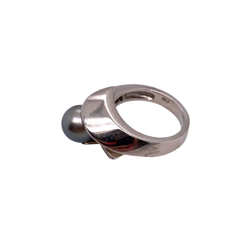 a silver ring with a ball on it