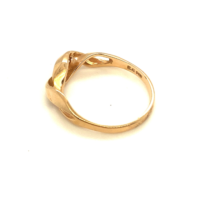 a yellow gold ring with two hearts on it
