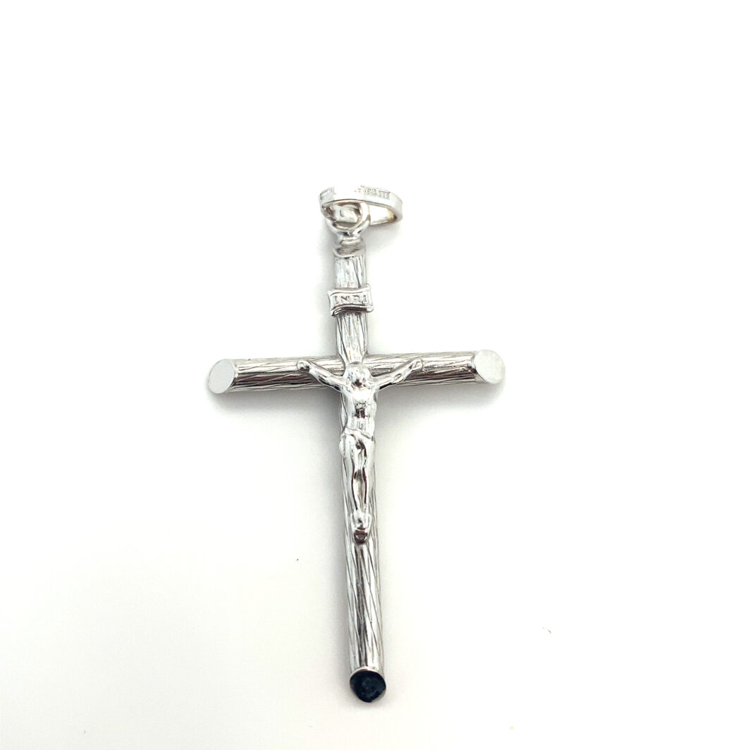 a silver cross with a black bead hanging from it