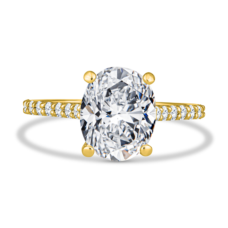 an oval cut diamond ring with yellow gold accents
