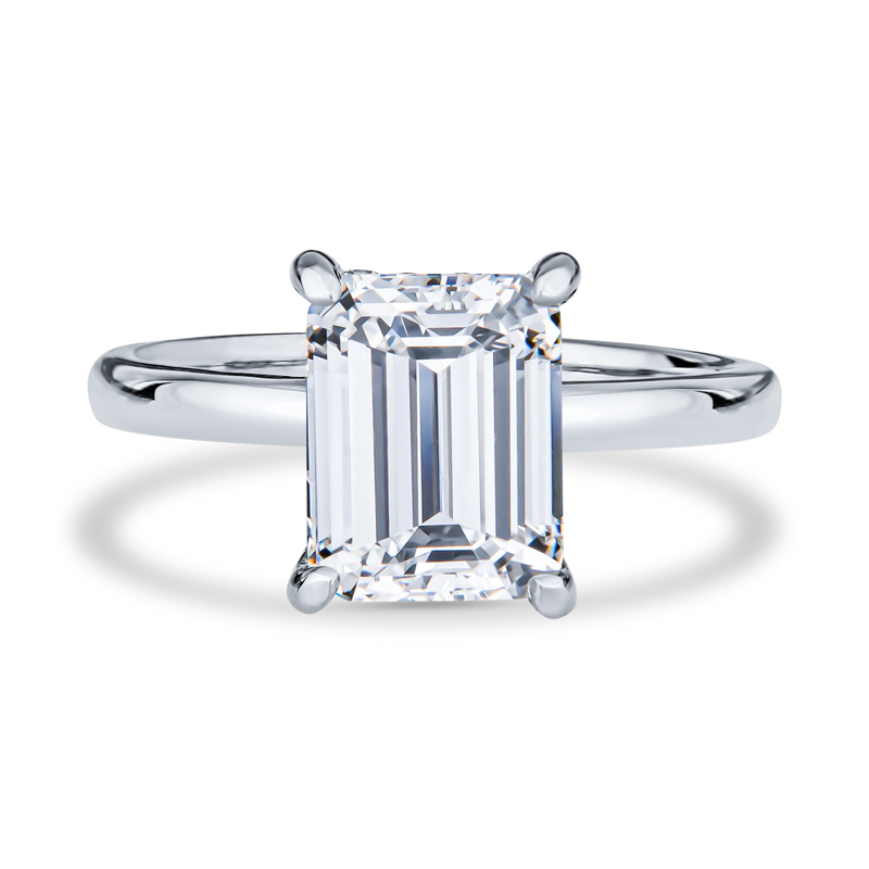 an emerald - cut diamond ring on a white background