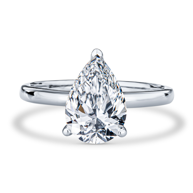 a pear shaped diamond ring with a thin band