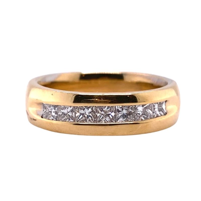 a yellow gold ring with princess cut diamonds