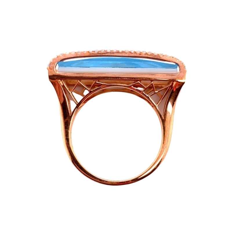 a gold ring with a blue stone in the center