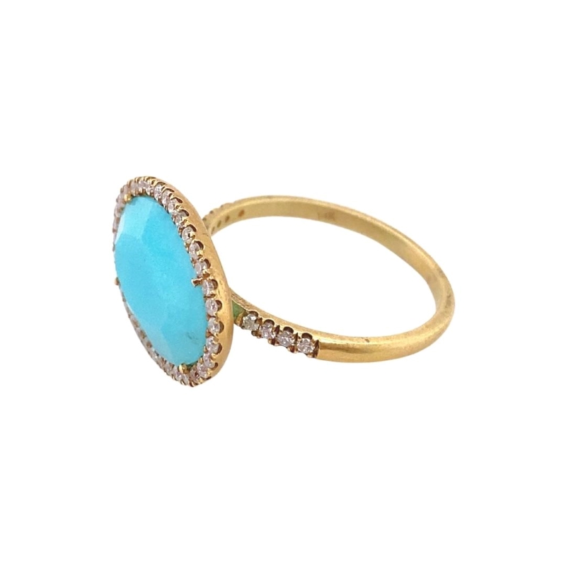 a gold ring with a turquoise stone and diamonds