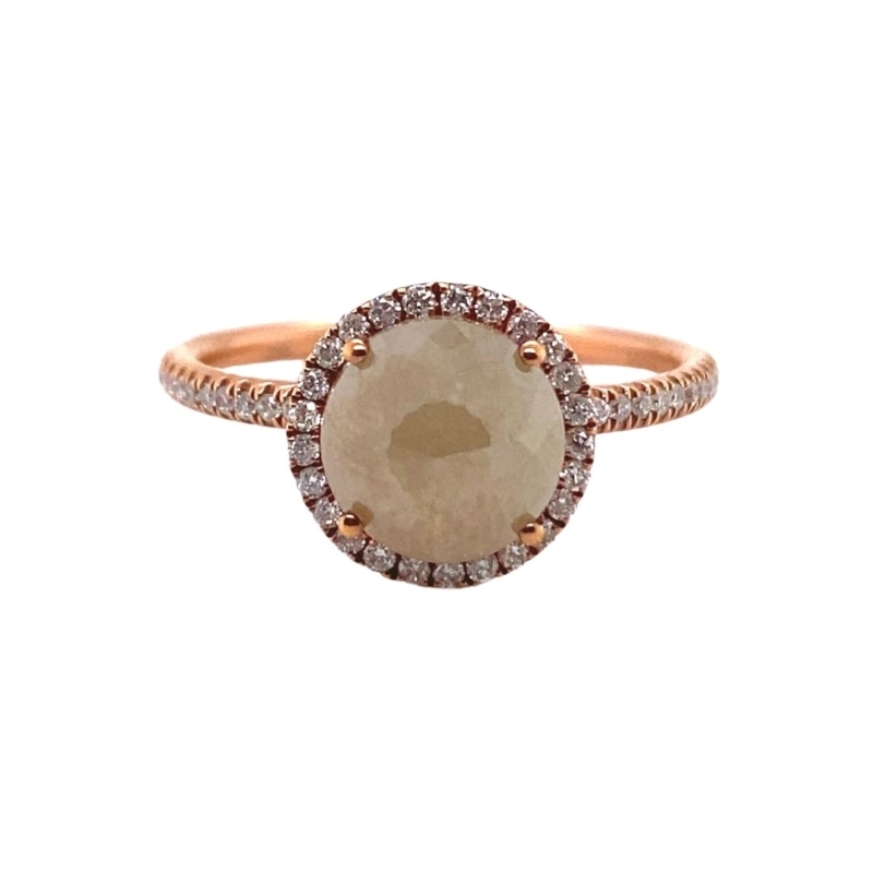 a ring with an oval shaped stone surrounded by small diamonds