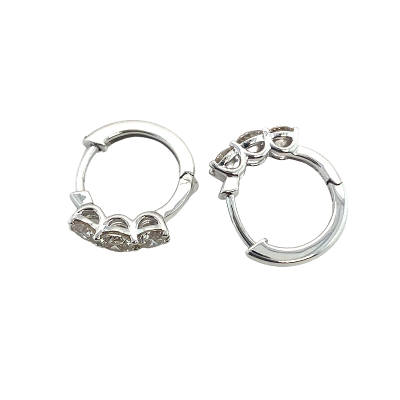 two pairs of silver hoop earrings on a white background