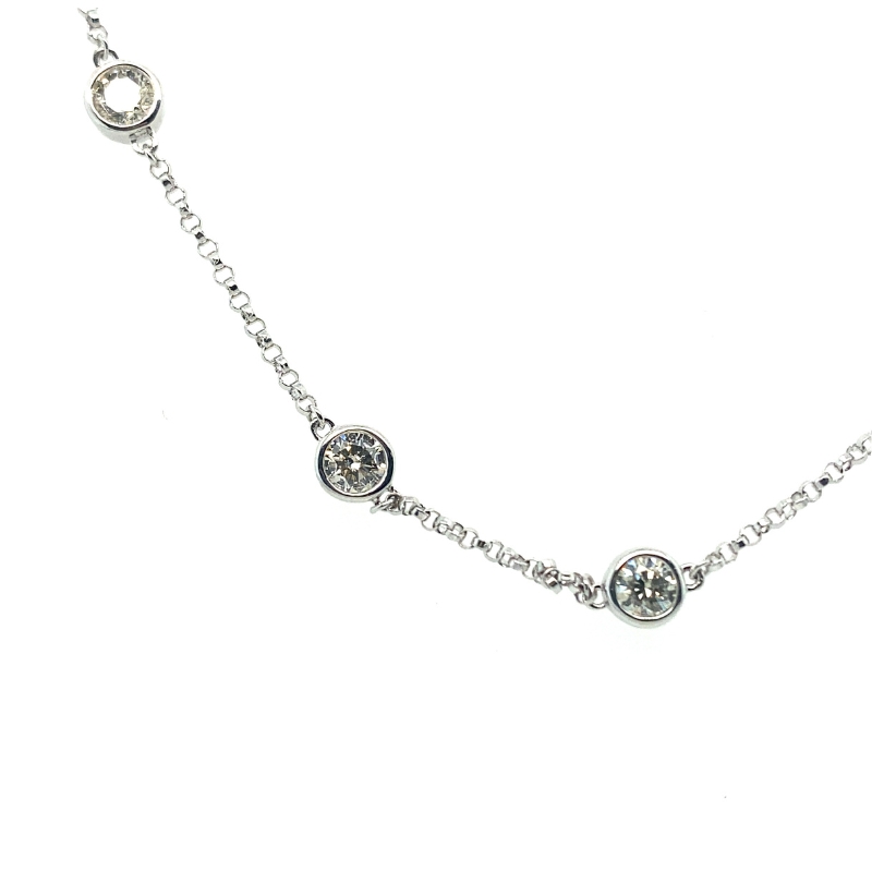 a silver necklace with three charms on it