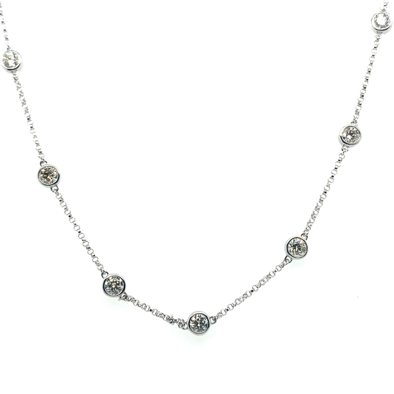 a silver necklace with three different beads on it
