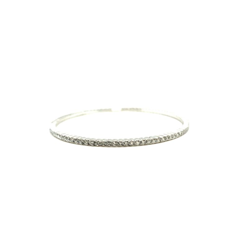 a thin silver bang bracelet with small diamonds