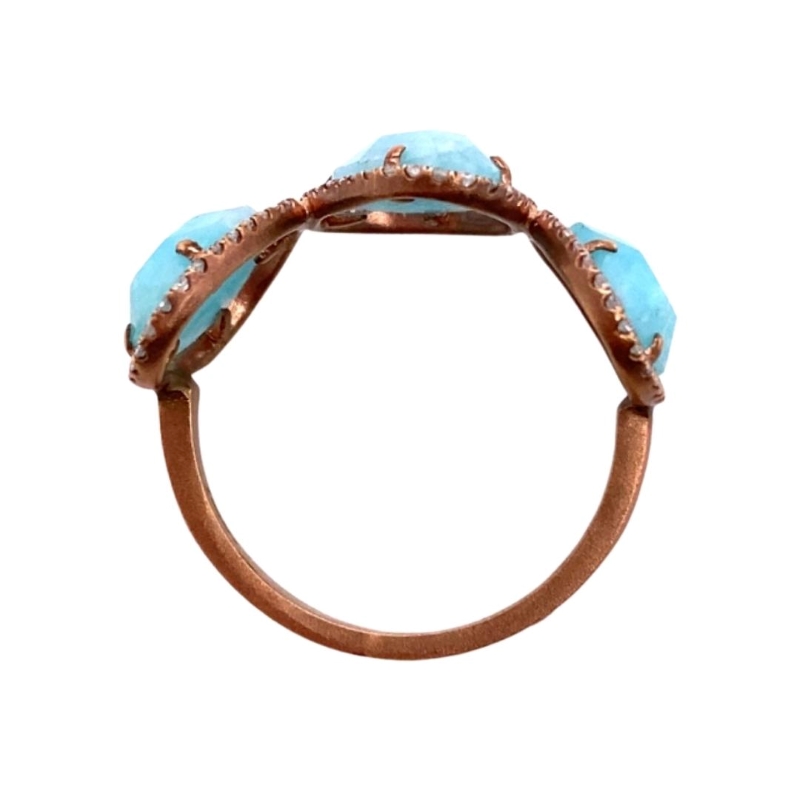 a ring with two turquoise stones on it