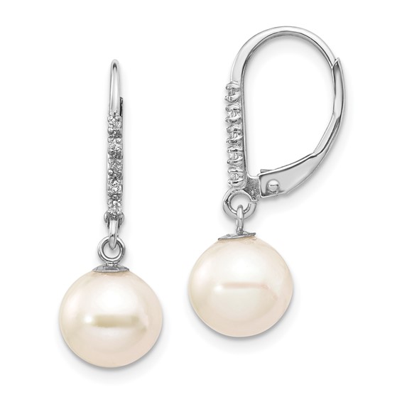 a pair of earrings with pearls and diamonds