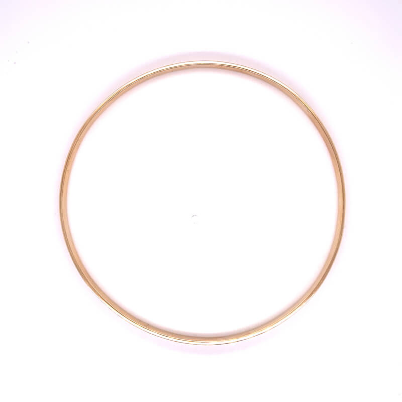 a gold colored metal ring on a white background