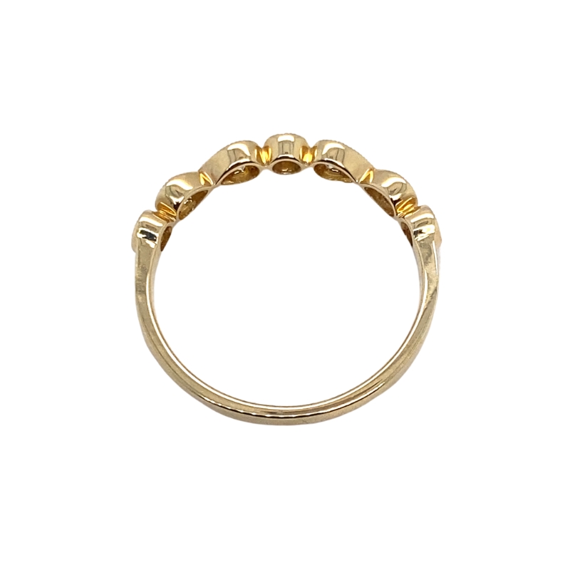 a gold ring with five small beads on it