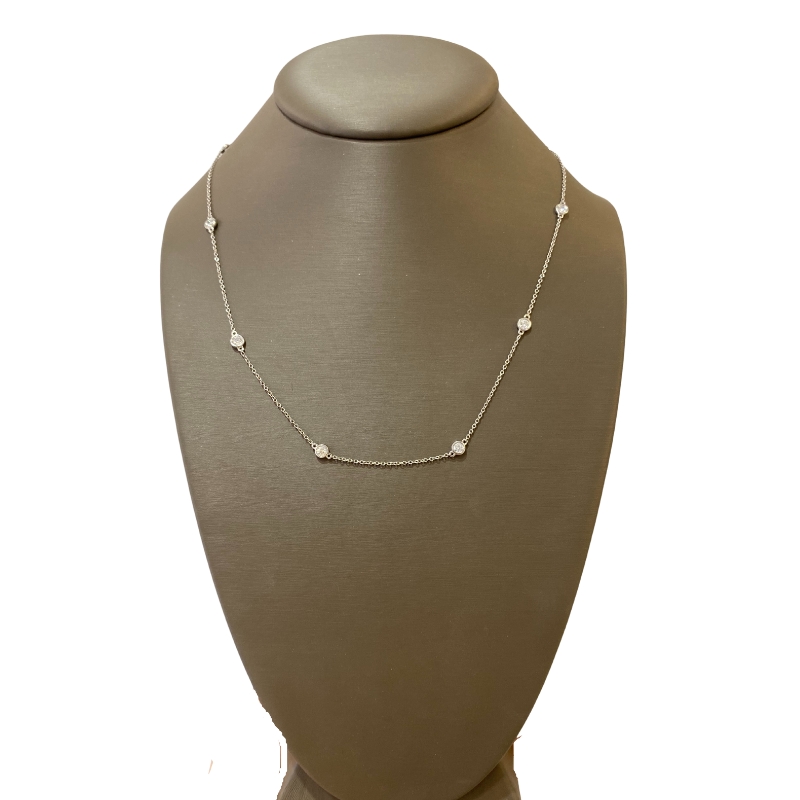 a necklace on a mannequin with white pearls