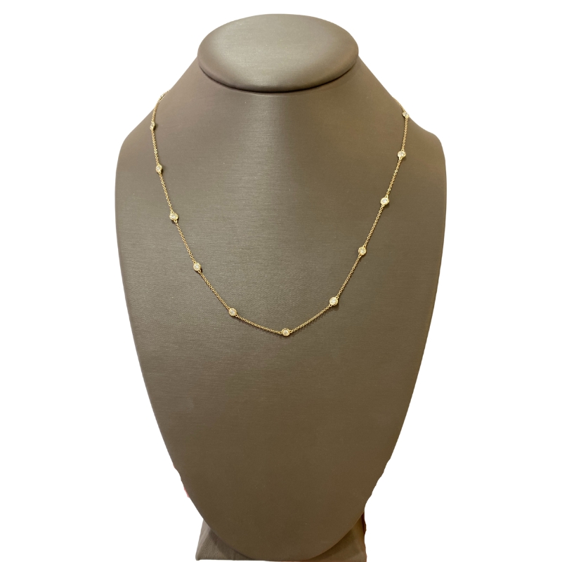 a gold necklace on a mannequin