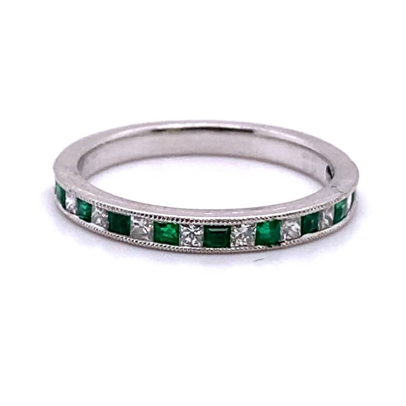 a white gold band with emeralds and diamonds