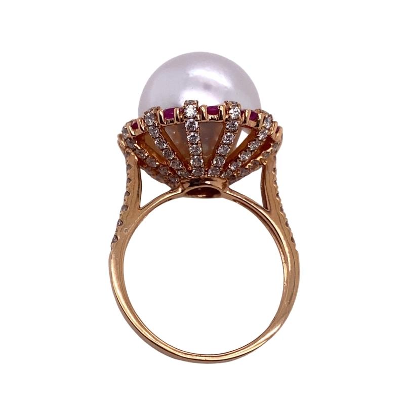 a pearl and diamond ring on a white background