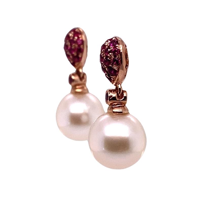 a pair of earrings with pearls and pink crystals