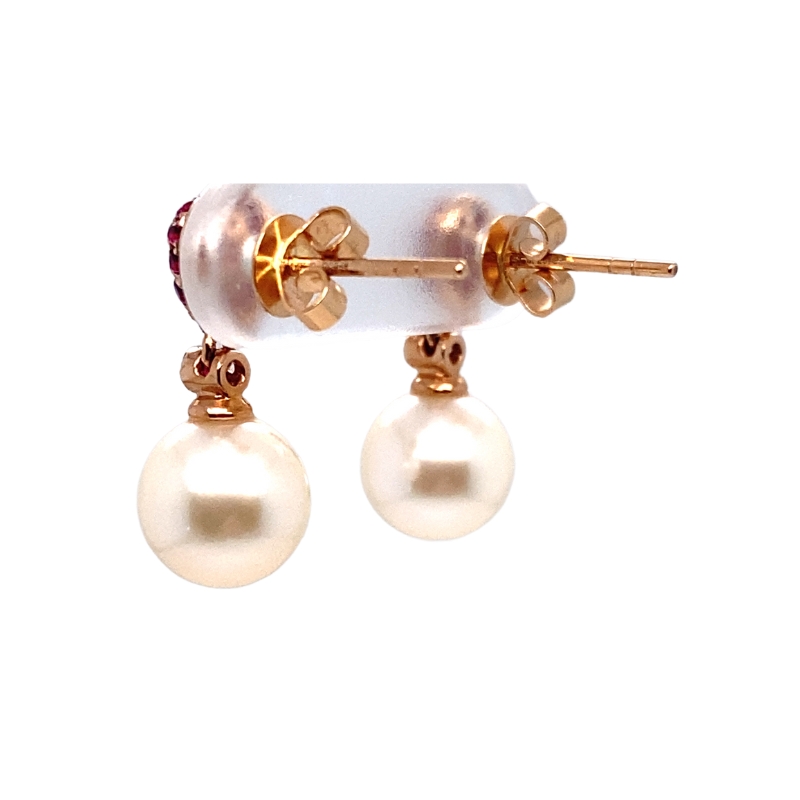 a pair of pearl and gold earrings