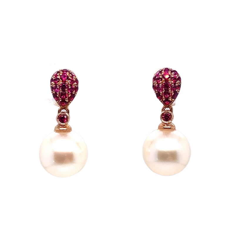 a pair of earrings with pearls and rubles