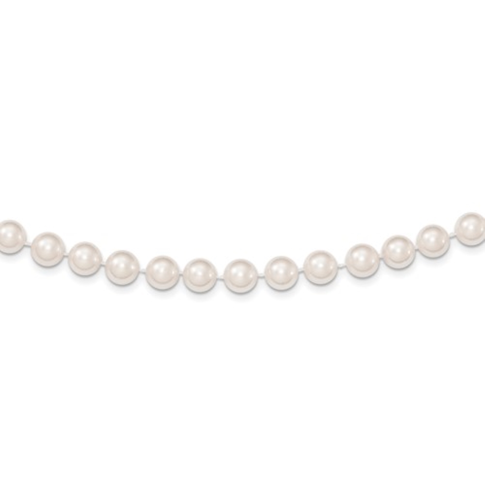 a strand of white pearls on a white background