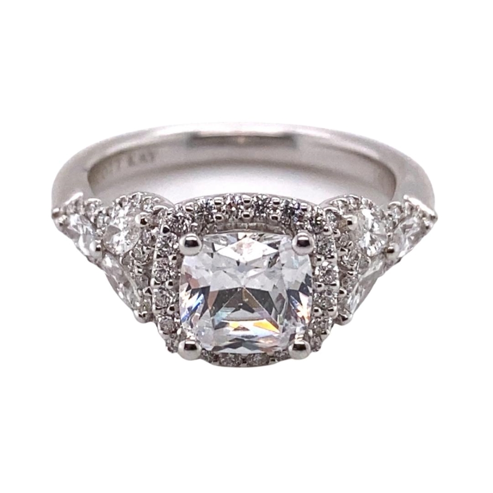 a white gold ring with a square cut diamond surrounded by smaller diamonds