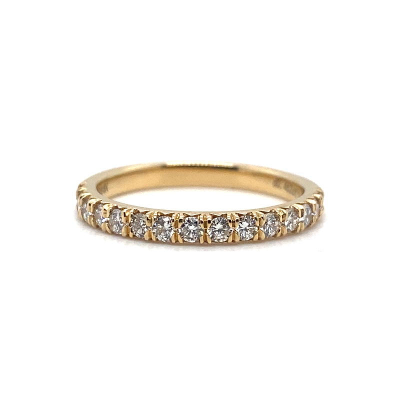 a yellow gold band with five diamonds