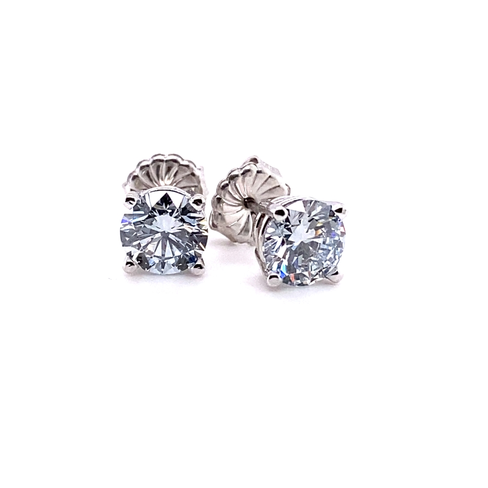 two pairs of diamond earrings on a white background