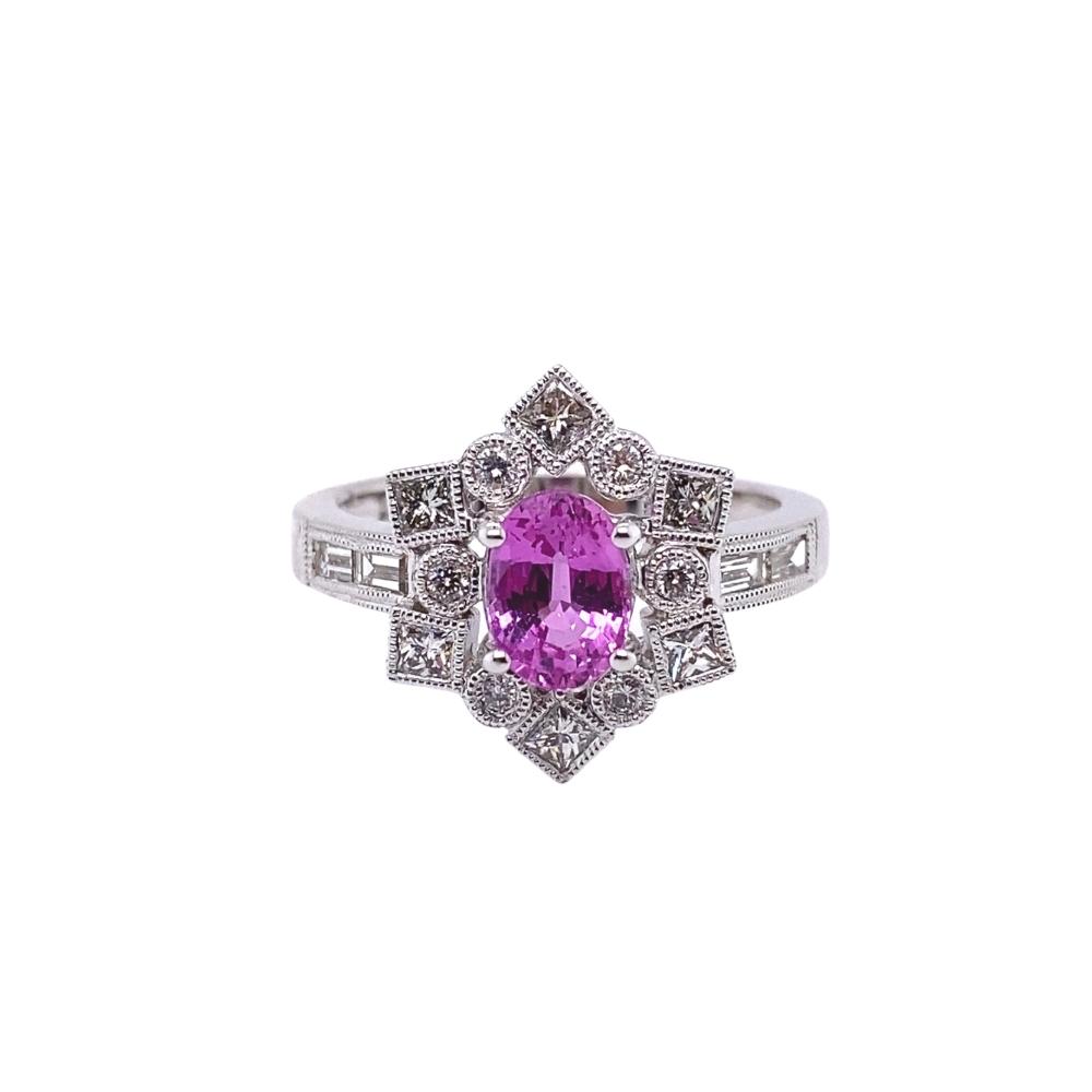a ring with an oval shaped purple stone surrounded by diamonds