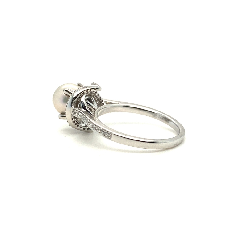 a white gold ring with a pearl and diamonds