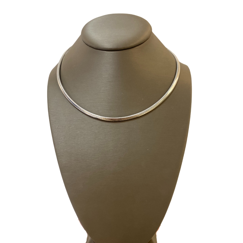 a necklace on a stand with a white background