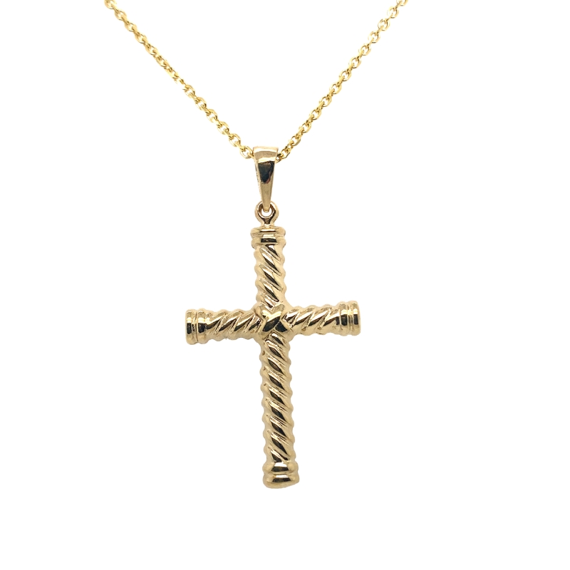 a gold cross pendant on a chain
