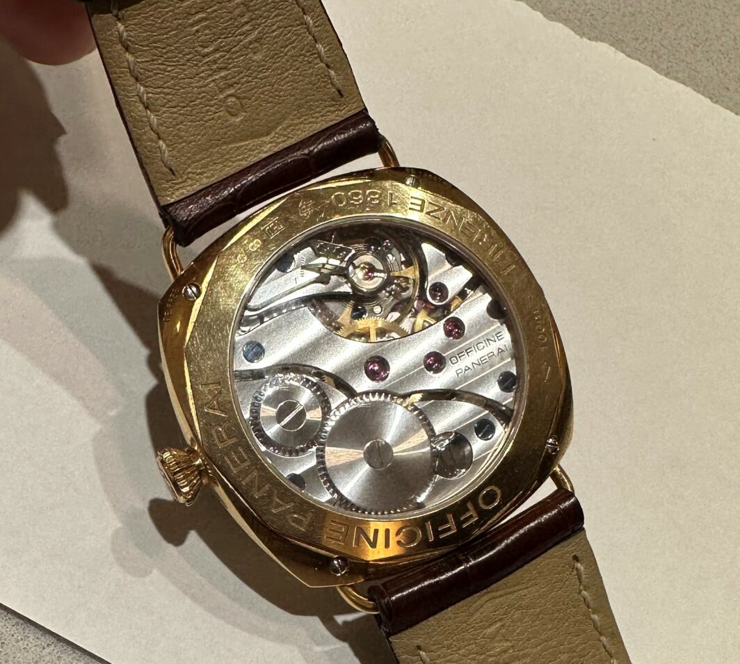 a gold watch sitting on top of a table