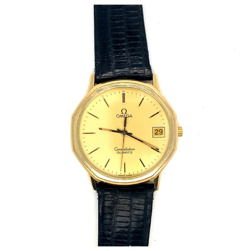 an old gold watch with black leather strap