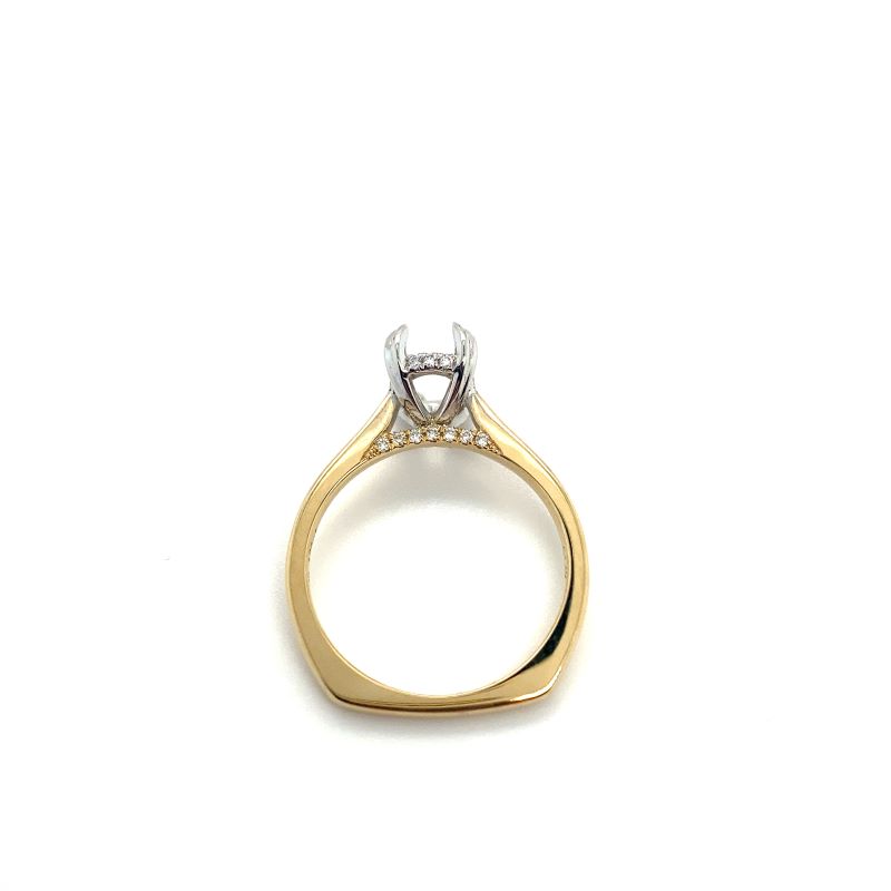 a yellow and white gold ring with a diamond