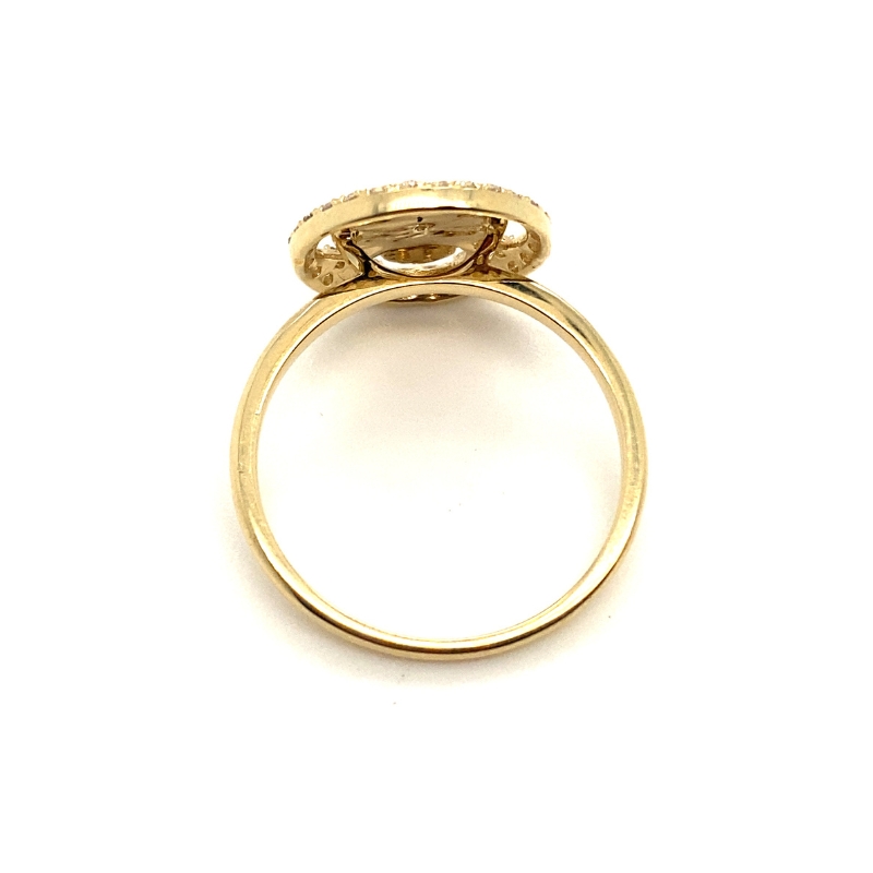 a yellow gold ring with an oval shaped diamond