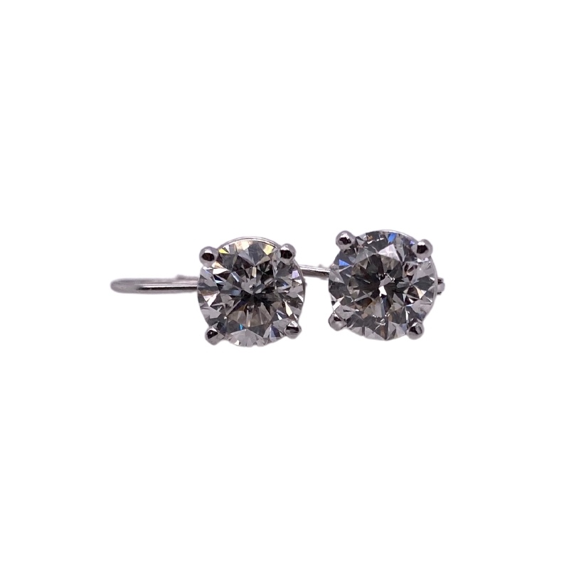 a pair of diamond stud earrings on a white background