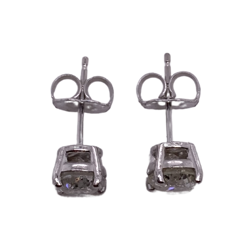 a pair of silver earrings with a car design