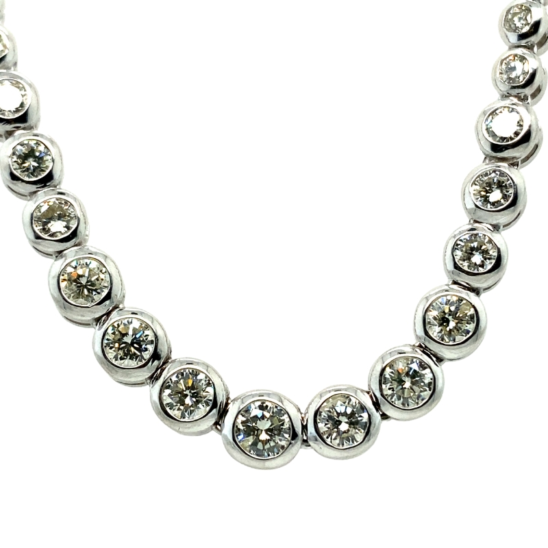 a necklace with several round diamonds on it