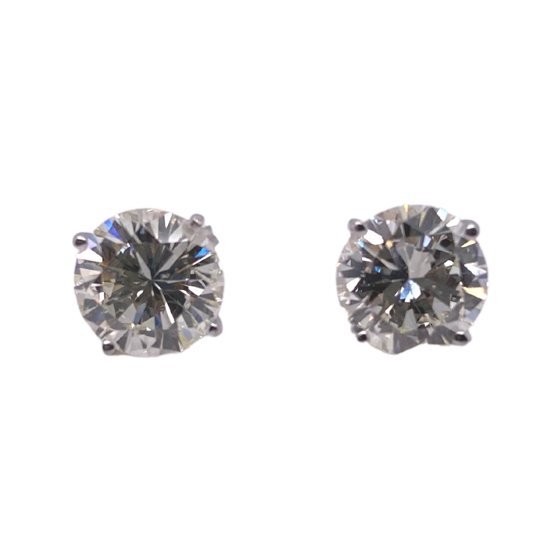pair of diamond stud earrings on white background