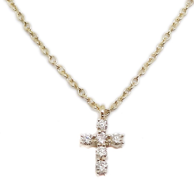 a cross necklace with three diamonds on it