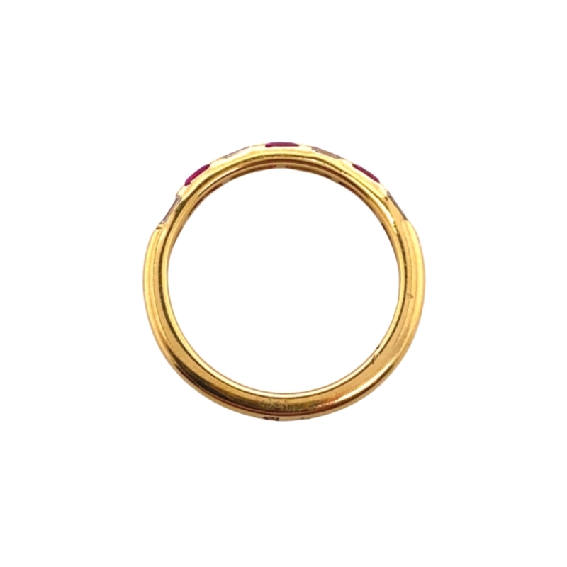 a gold ring with red stones on it