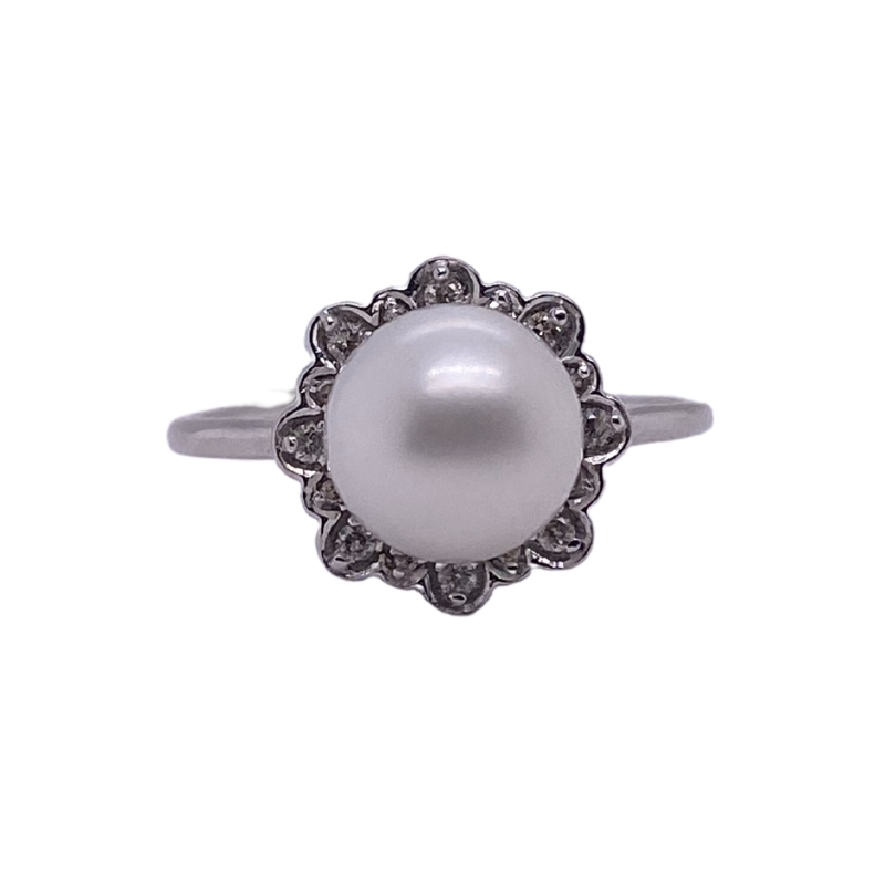 a ring with a white pearl in the center