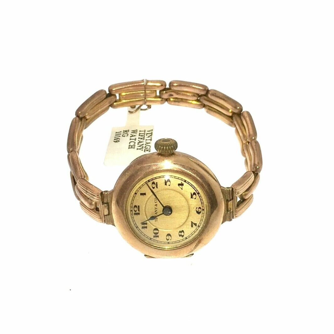 an old gold watch with a chain around it