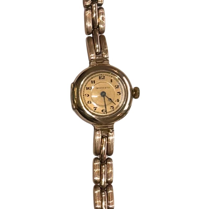 a gold watch with a chain link strap