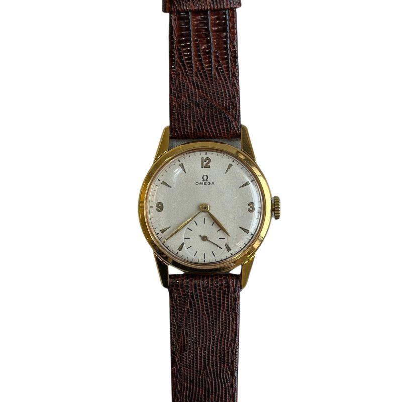an old watch with brown leather strap