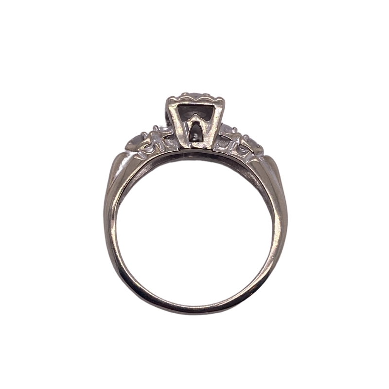 a diamond ring with three stones on the side